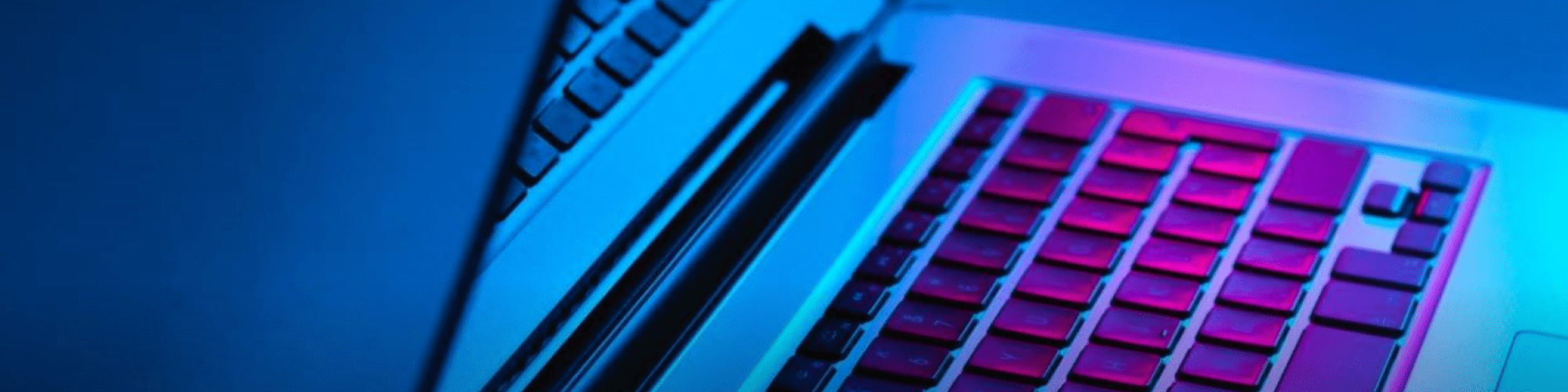  a laptop with a purple glare on the keyboard