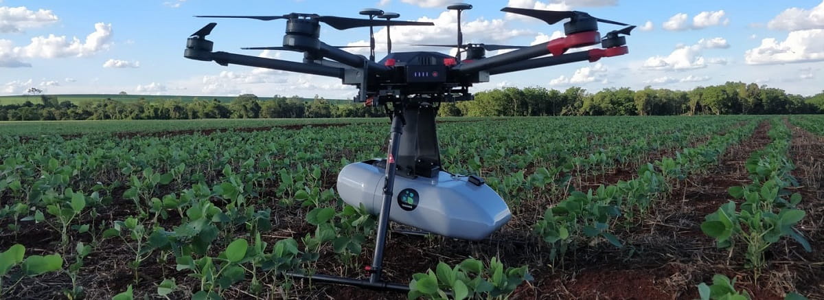 A drone hovering over an agricultural field